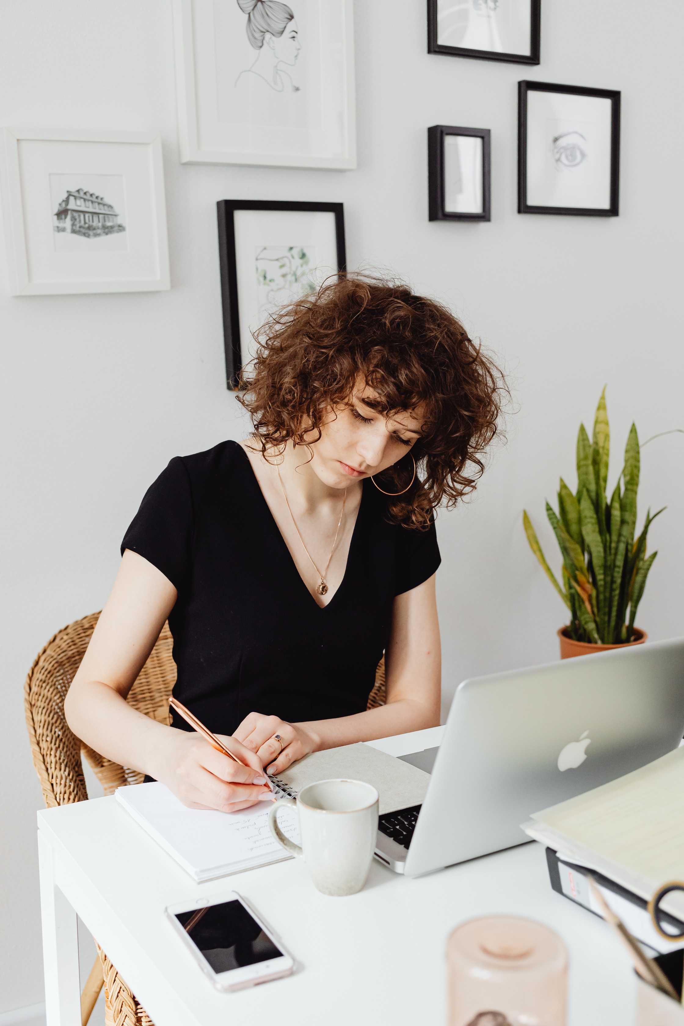 Woman Writing on a Notebook